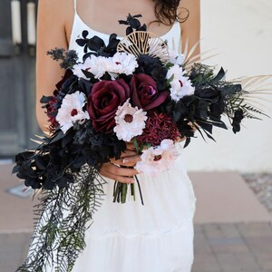 Dark Moody Asymmetrical Cascading Bridal Bouquet Black Deep Red Roses Anemone Flowers Black  Gold Palm Leaves Vintage Gothic Wedding Vibe