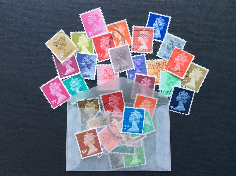 May include: A collection of vintage postage stamps featuring the profile of Queen Elizabeth II. The stamps are in various colors and denominations, including 5p, 20, 25, 39, 41, 50, and 54. The stamps are arranged in a circle around a clear plastic envelope.