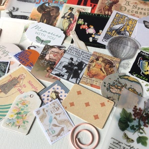 May include: A collection of vintage ephemera, including postcards, tags, and illustrations. The assortment features images of butterflies, birds, and botanical elements, along with text that reads "Memories with you", "Happy Day", and "Simple to mail". A decorative paper clip is also included.