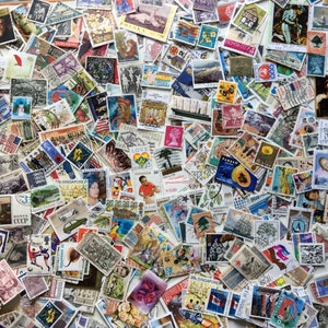 May include: A close-up view of a large assortment of postage stamps, showcasing a variety of designs, portraits, and scenic views. The stamps are tightly packed, forming a textured, mosaic-like composition. The stamps are of different sizes and shapes, including rectangular and square.