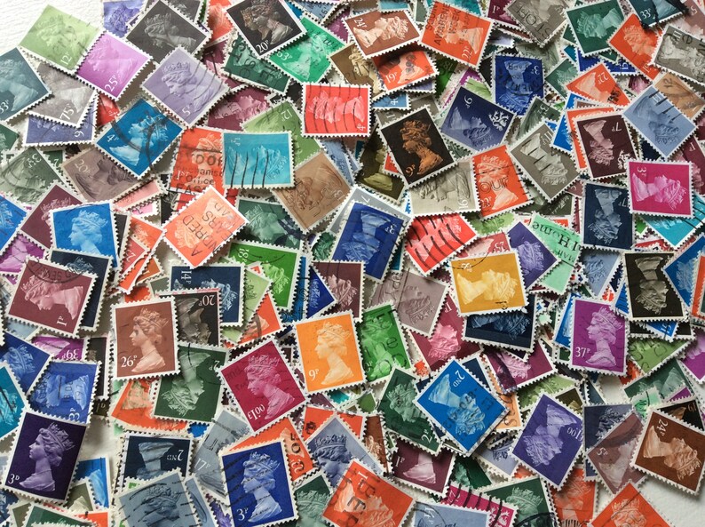May include: A collection of vintage postage stamps featuring a variety of designs and colors. The stamps are mostly rectangular and have a serrated edge. Some of the stamps feature a portrait of a woman, while others feature images of buildings, animals, and other objects.