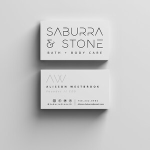 May include: Two white business cards with black text. The top card reads "SABURRA & STONE BATH + BODY CARE". The bottom card reads "AW ALISSON WESTBROOK Founder // CEO @SaburraStonelG 758.232.0986 Alisson.Saburra@email.com".
