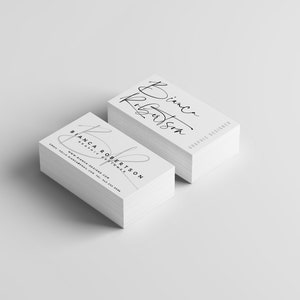 May include: A stack of white business cards with the name Bianca Robertson and the title Graphic Designer printed in black ink.