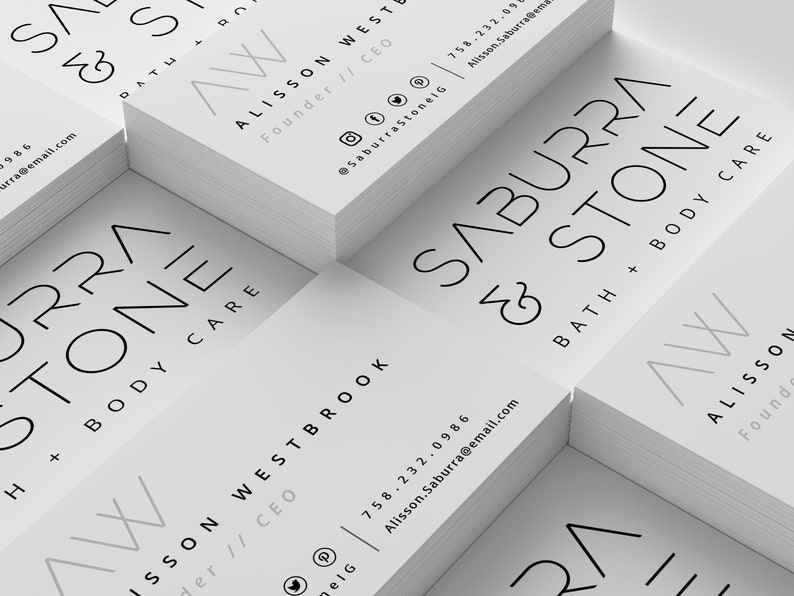 May include: A stack of white business cards with the text "Saburra & Stone Bath + Body Care" and the logo "AW" in a gray color. The text "Alisson West Founder // CEO" and contact information is also included on the cards.