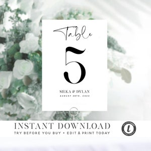 May include: White table number card with black calligraphy text that reads "Table 5" and "Silka & Dylan August 28th, 2022".