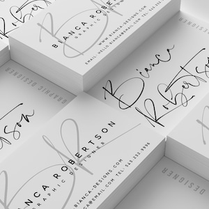 May include: A stack of white business cards with a black and gray graphic design logo and the text "Bianca Robertson Graphic Designer" and contact information.