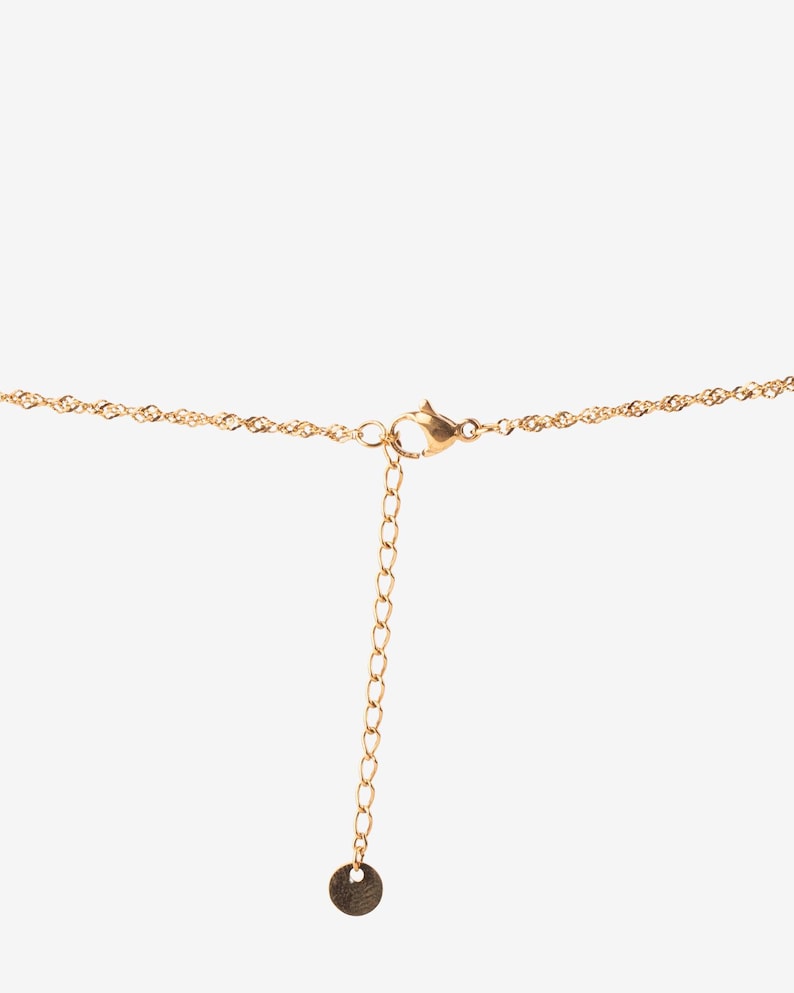 May include: A gold chain necklace with a lobster clasp and a small round pendant.