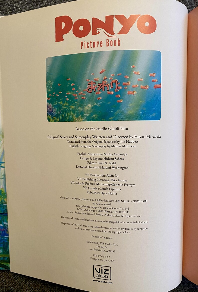 May include: Open book page featuring the title "PONYO Picture Book" in red letters. The image shows an underwater scene with fish. Text in Japanese and English details the book's creators and publisher.