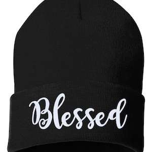May include: Black beanie with a white embroidered word "Blessed" on the front.