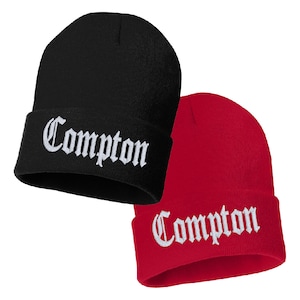 May include: Two knit beanies, one black and one red, with the word "Compton" embroidered in white on the front of each.