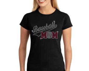 May include: Black t-shirt with a rhinestone design that says "Baseball Mom" with a baseball graphic in the middle of the word "Mom".