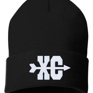 May include: Black knit beanie with a white embroidered arrow and the letters "XC" on the front.