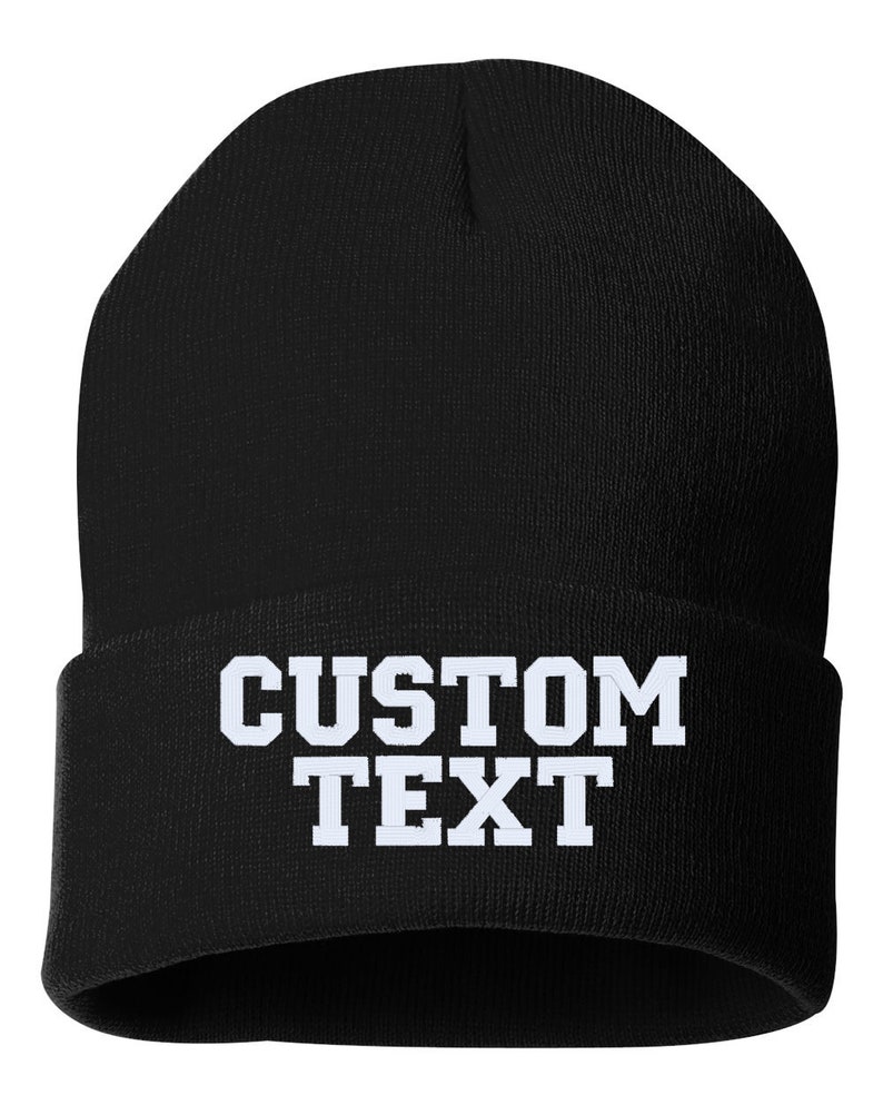 May include: Black knitted beanie with white text that reads "CUSTOM TEXT".