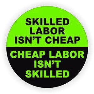 May include: A round sticker with a black and green design. The top half is green with the text "SKILLED LABOR ISN'T CHEAP" in black. The bottom half is black with the text "CHEAP LABOR ISN'T SKILLED" in white.