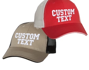 May include: Two baseball caps, one red and one tan, with white text that reads "CUSTOM TEXT". The red cap has a white mesh back, and the tan cap has a black mesh back. Both caps have a curved brim.