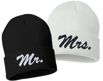 May include: A pair of black and white knit beanies with the words "Mr." and "Mrs." embroidered on them.