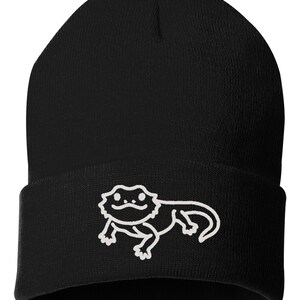 May include: Black beanie with a white outline of a bearded dragon on the front.
