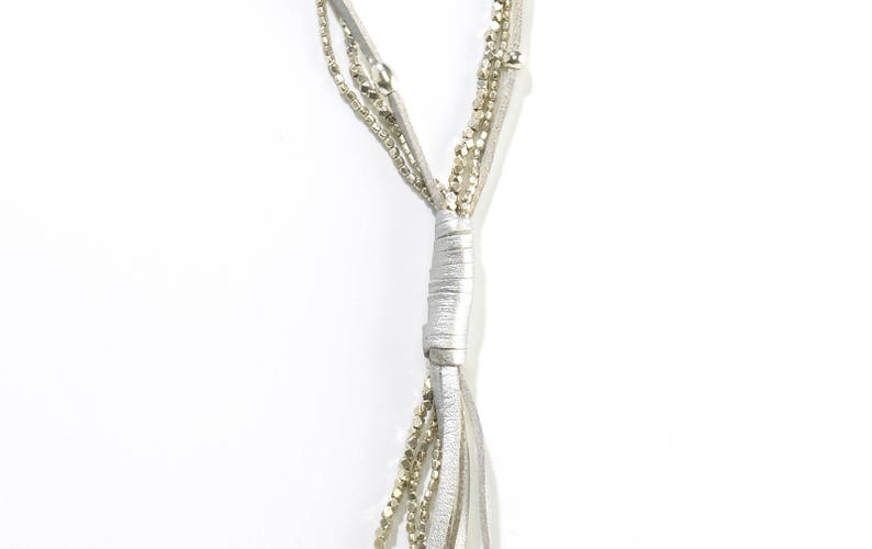 May include: A silver multi-strand necklace with a leather cord and small beads.