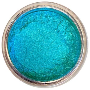 May include: A small round container of teal blue iridescent loose pigment powder.