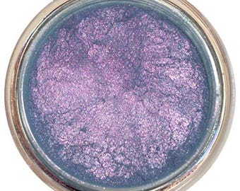 May include: A small round jar of iridescent blue and purple eyeshadow.