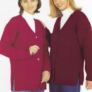 May include: Two women wearing long-sleeved cardigans. The cardigan on the left is a bright pink color and the cardigan on the right is a deep burgundy color. Both cardigans have a V-neck and button closure.