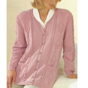May include: A pink knitted cardigan with a cable knit pattern and a v-neck. The cardigan has pockets and buttons down the front.