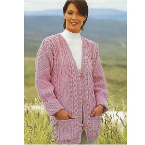 May include: A pink cable knit cardigan with a V-neck, button fastening, and two pockets. The cardigan is made from a soft, warm yarn and has a classic, timeless style.