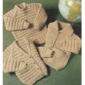 May include: Three knitted sweaters in a beige color. One sweater has a zipper closure, one has buttons, and one is a crew neck pullover.