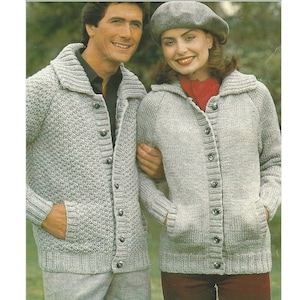 May include: Two knitted cardigans with button closures and pockets. The cardigans are a light gray color and have a textured knit pattern.