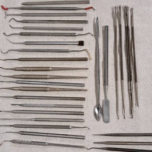 Collection of 40 stainless dental and surgical instruments