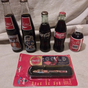 Collection of vintage coke bottles and memorabilia