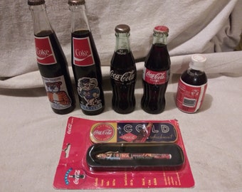 Collection of vintage coke bottles and memorabilia