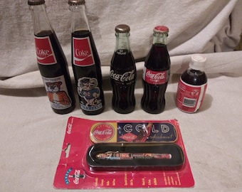 Collection of vintage coke bottles and memorabilia