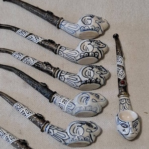 Collection of 7 hand made asian porcelain tobacco pipes