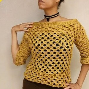 May include: A mustard yellow crochet top with a loose, open-weave design. The top has a wide, boat neckline and three-quarter sleeves.