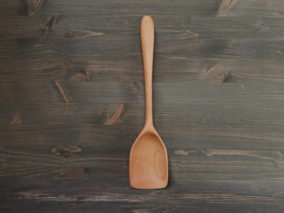 A real craftsperson carved this beechwood serving spoon by hand — the kind of tactile, heirloom-quality kitchen tool that makes a $55 gift feel genuinely personal.