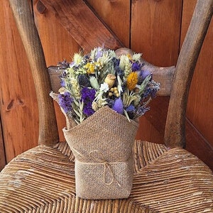 Dried flower arrangement. Home décor rustic and countryside vibe. Hessian. Gift decoration. Yellow White. Purple. Blue .Grasses floral.