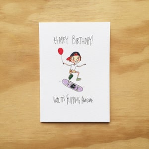 May include: A birthday card with a cartoon illustration of a person skateboarding and holding a red balloon. The card says "Happy Birthday!" and "Hope it's flipping awesome."