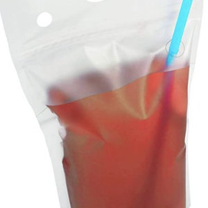 May include: A clear plastic pouch with a blue straw sticking out of the top. The pouch is filled with a red liquid.