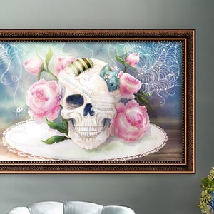 May include: A framed watercolor painting of a human skull with a lace veil and surrounded by pink roses. The background is a blue and white watercolor wash with a spiderweb design.
