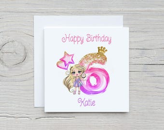 May include: A pink and purple birthday card with a cartoon girl holding balloons and a crown. The card says "Happy Birthday Katie".