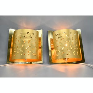 Set of two matching perforated brutalist brass wall lamps by Borens Sweden, 1970s