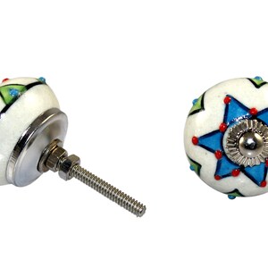 May include: White ceramic knob with a blue star design and red and green accents. The knob has a silver screw.