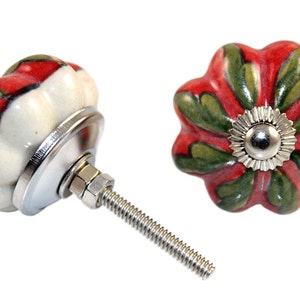 May include: Two ceramic cabinet knobs with a red, white, and green floral design. The knobs have a silver metal base and screw.
