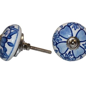 Può includere: Pomo in ceramica blu e bianco con un motivo floreale. Il pomo ha una vite argentata.