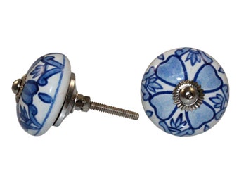 May include: Blue and white ceramic knob with a floral design. The knob has a silver screw.