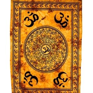May include: A tapestry with a yellow and orange background featuring a circular design with the word "Om" in the centre. The design is surrounded by a border of "Om" symbols. The tapestry has a fringed edge.