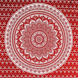 May include: A white mandala design on a red background. The mandala is intricate and detailed, with a circular pattern of flowers and leaves.