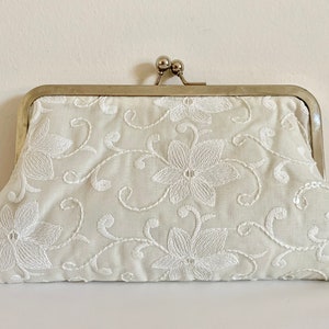Bridal ivory clutch bag in beautiful embroidered sequined cotton embellished fabric.
