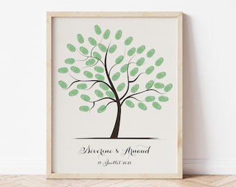 May include: A framed print featuring a tree design with green leaf-shaped fingerprints. The tree trunk and branches are brown, and the print includes the names "Severine & Arnaud" and the date "17 Juillet 2021" in elegant script.